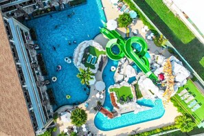 An aerial view of a resort with multiple swimming pools, including a large central pool and smaller pools connected by slides. - Ananta Burin Resort (Krabi)