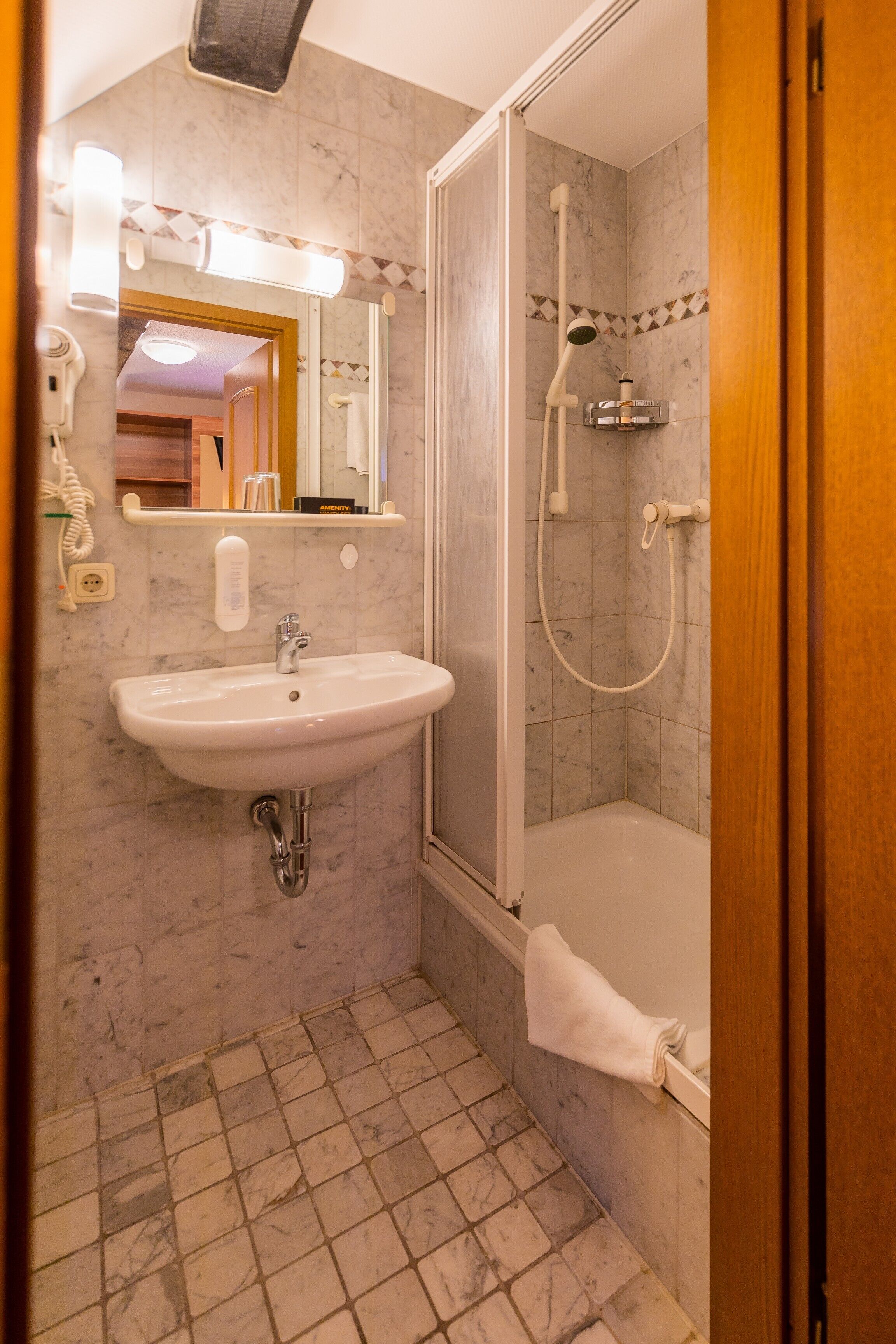 premium single room | bathroom | shower, hair dryer, towels, soap