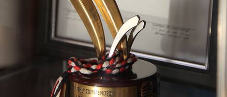 A trophy with a star on top, placed on a stand with a plaque that reads "Highly Commended Best 3 Star Hotel Excellence in Tourism Awards".