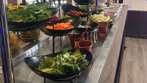 A buffet with various food items including salads, vegetables, and fruits. - Golden Tulip Al Khobar (Al Khobar)
