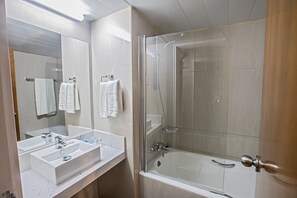 A modern bathroom with a glass-enclosed shower, a large mirror, and a white sink. - Nelia Sea Breeze (Ayia Napa)