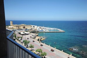 A coastal town with a marina, a historic building, and a paved promenade overlooking the sea. - Sliema Chalet Hotel (Sliema)