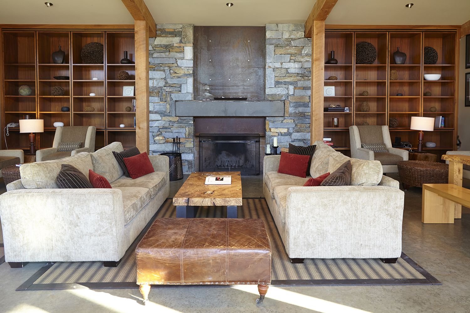 A spacious living room with two sofas, a coffee table, and a fireplace.