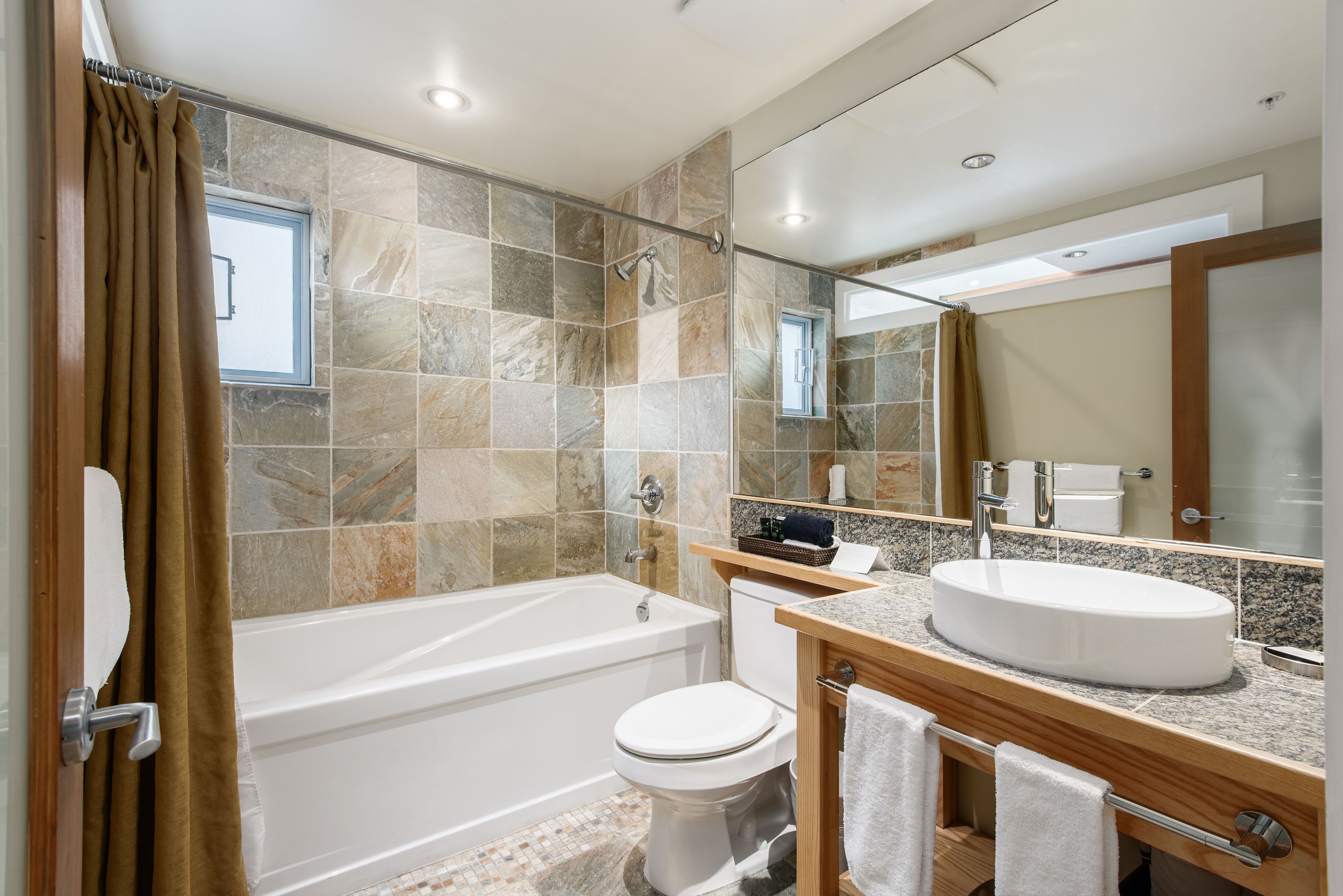 combined shower/bathtub, designer toiletries, hair dryer, bathrobes