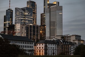 A cityscape with modern high-rise buildings and older residential structures.
