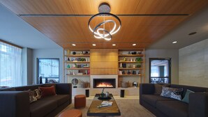 A modern living room with two sofas, a coffee table, and a fireplace. - Adina Apartment Hotel Berlin Mitte (Berlin)