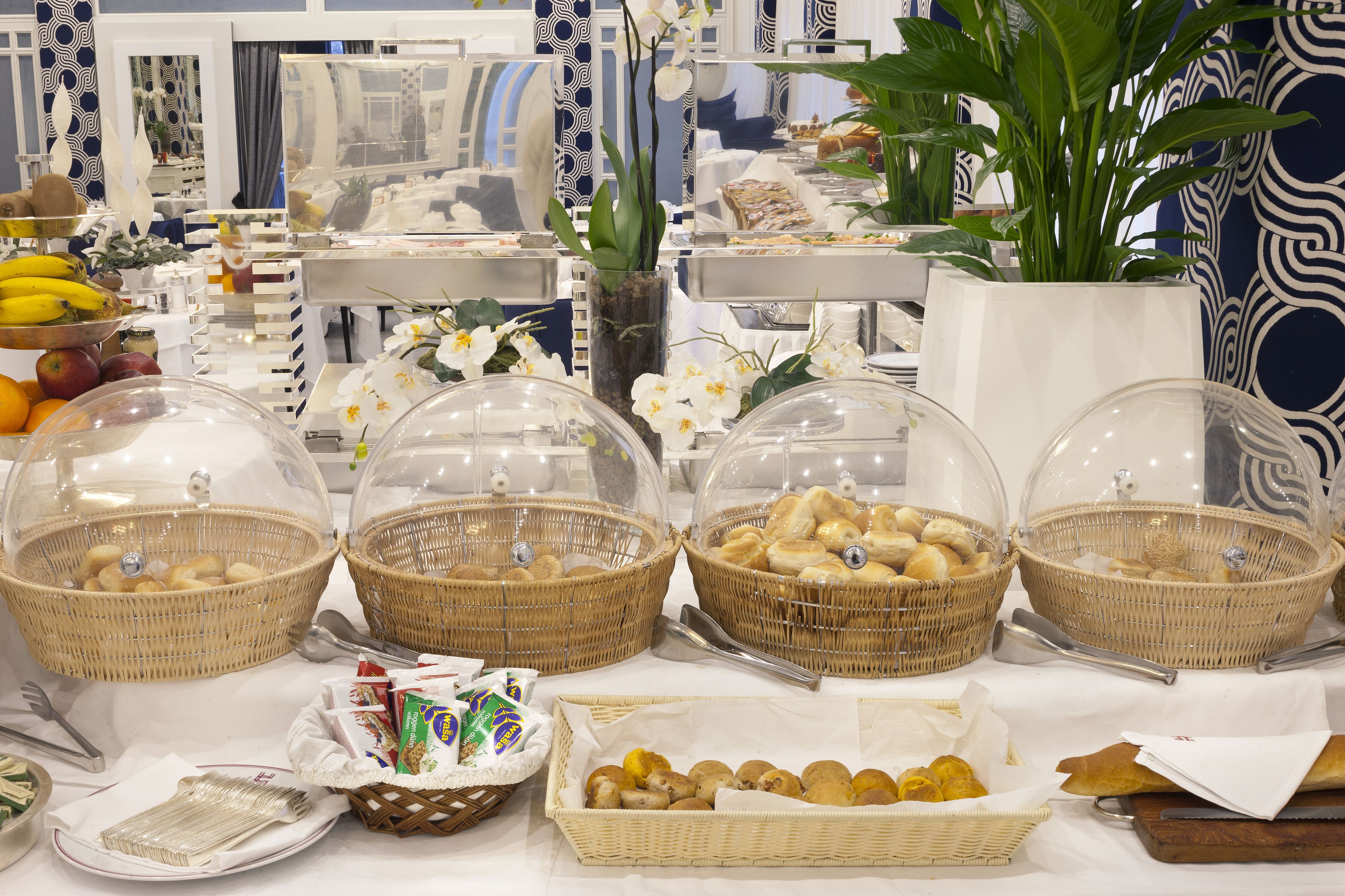 A buffet table with various food items and baskets.