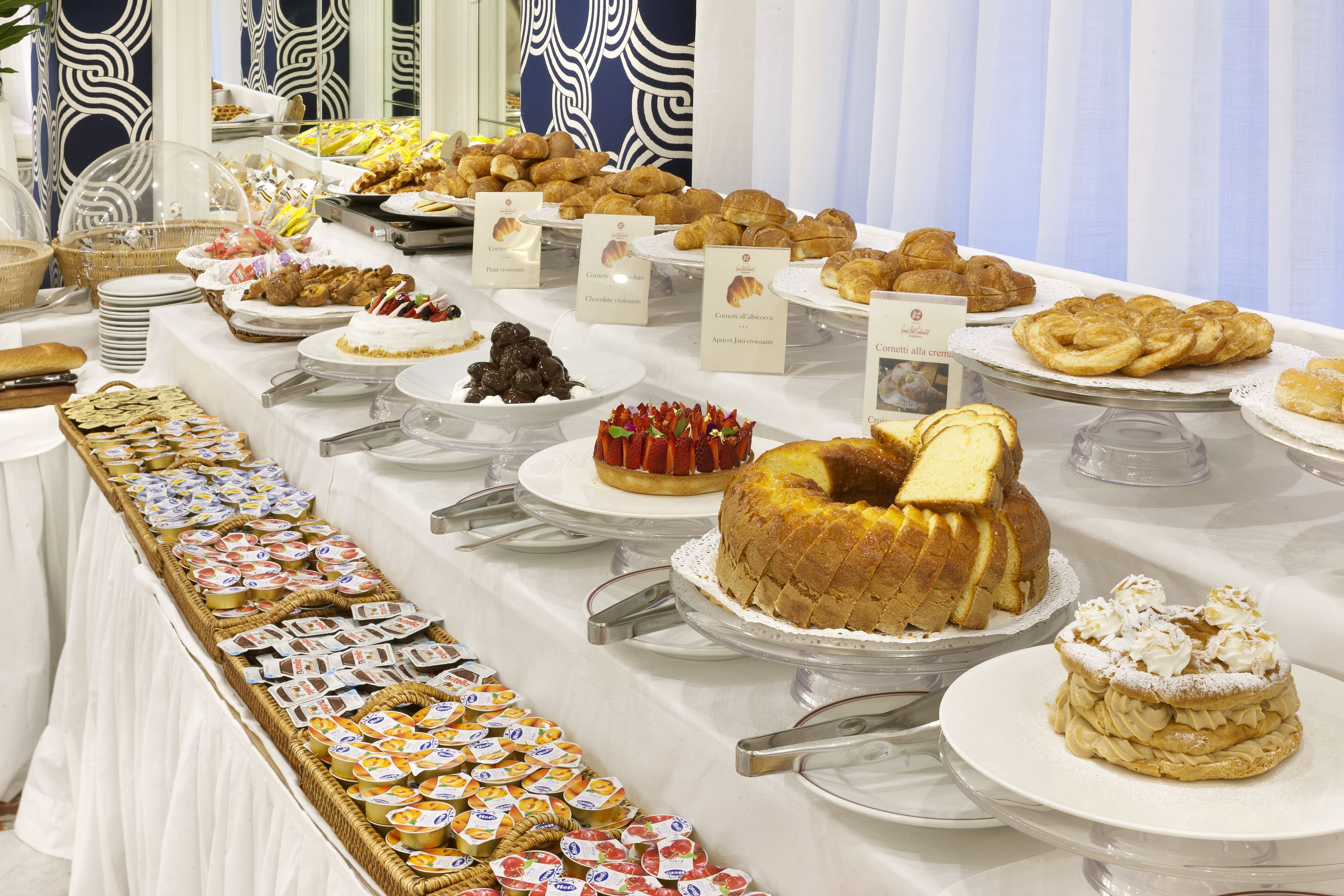 A buffet with various pastries and desserts.