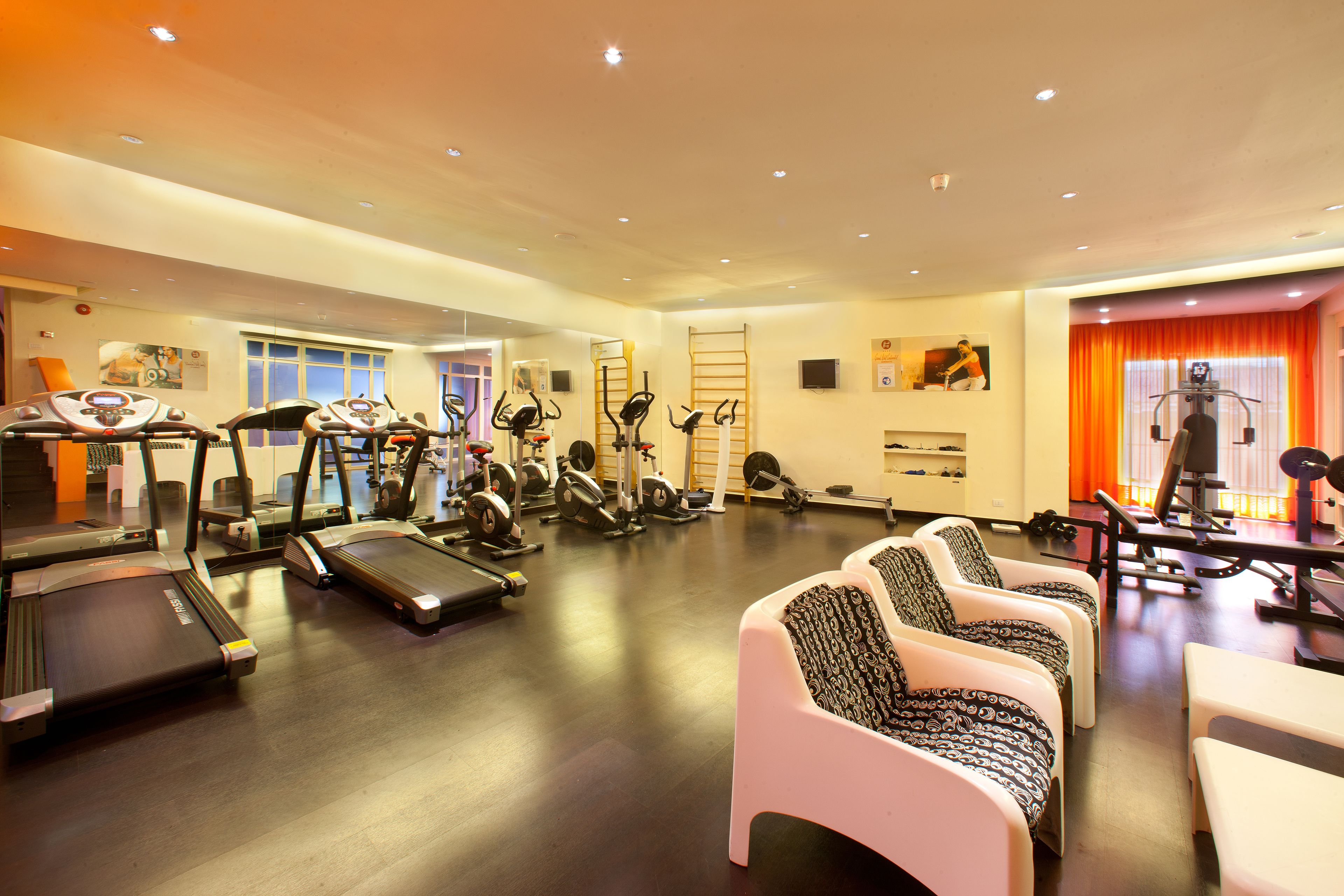 A gym with treadmills, stationary bikes, and weight machines.
