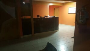A reception area with a desk, a phone, and a computer monitor. - Motel 6 Prairie Du Chien, WI (Prairie Du Chien)