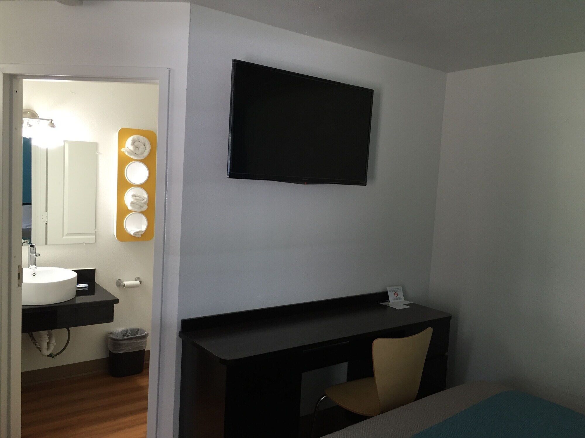 A modern bathroom with a sink, mirror, and vanity.