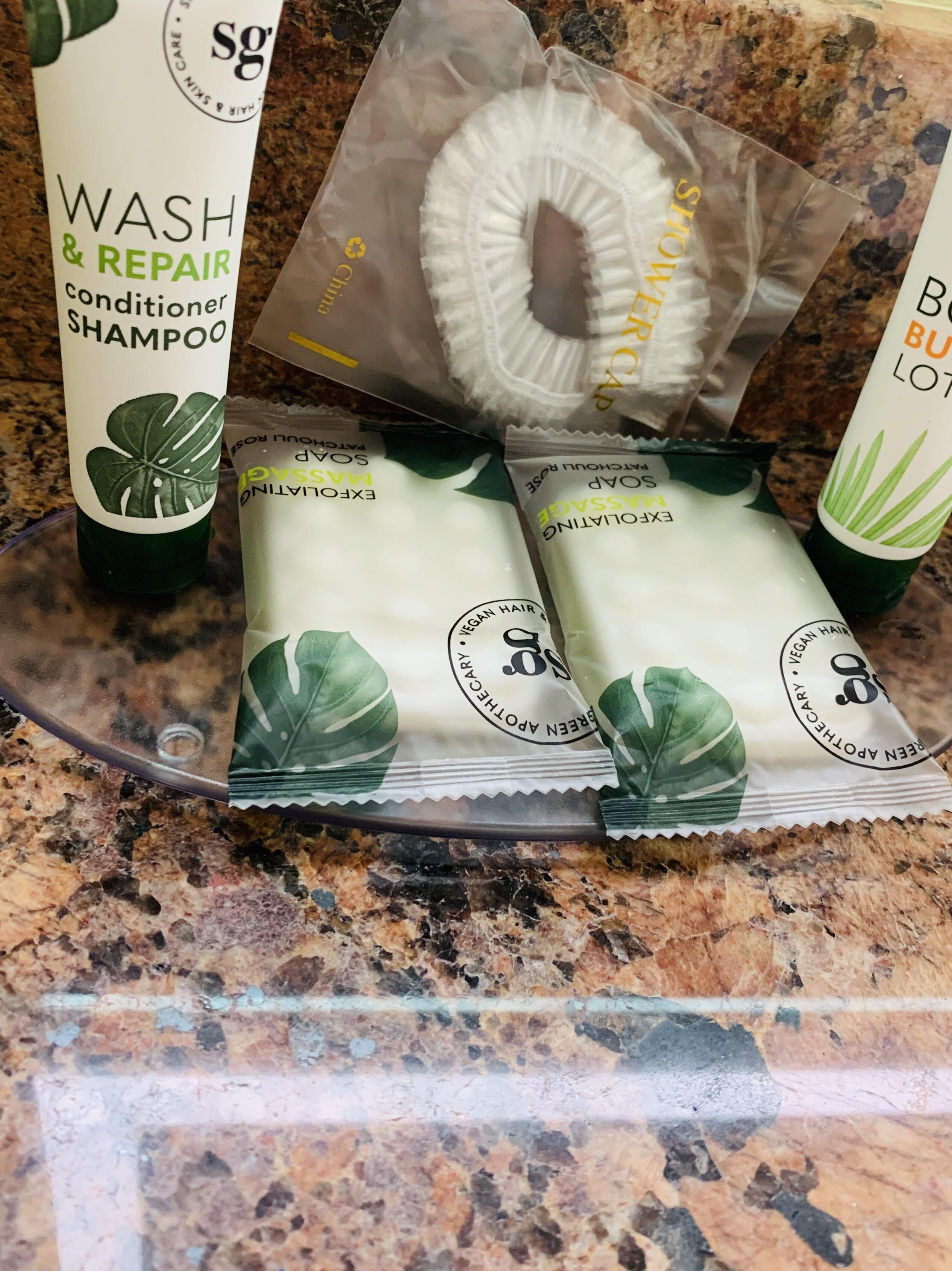 A countertop with a variety of personal care products, including shampoo, conditioner, and body lotion.