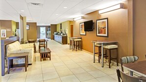 A hotel lobby with a reception desk, seating area, and a kitchenette. - Microtel Inn & Suites by Wyndham Bryson City (Bryson City)