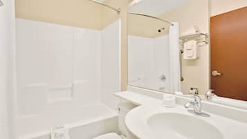 A modern bathroom with a bathtub, toilet, and sink.