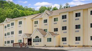 A multi-story hotel with a symmetrical facade, multiple windows, and a central entrance with a small porch. - Microtel Inn & Suites by Wyndham Bryson City (Bryson City)