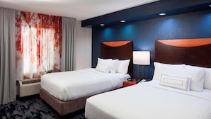 A hotel room with two beds, a large window with sheer curtains, a wall-mounted air conditioner, and a nightstand with a lamp. - Fairfield by Marriott Inn & Suites Austin Parmer/Tech Ridge (Austin)