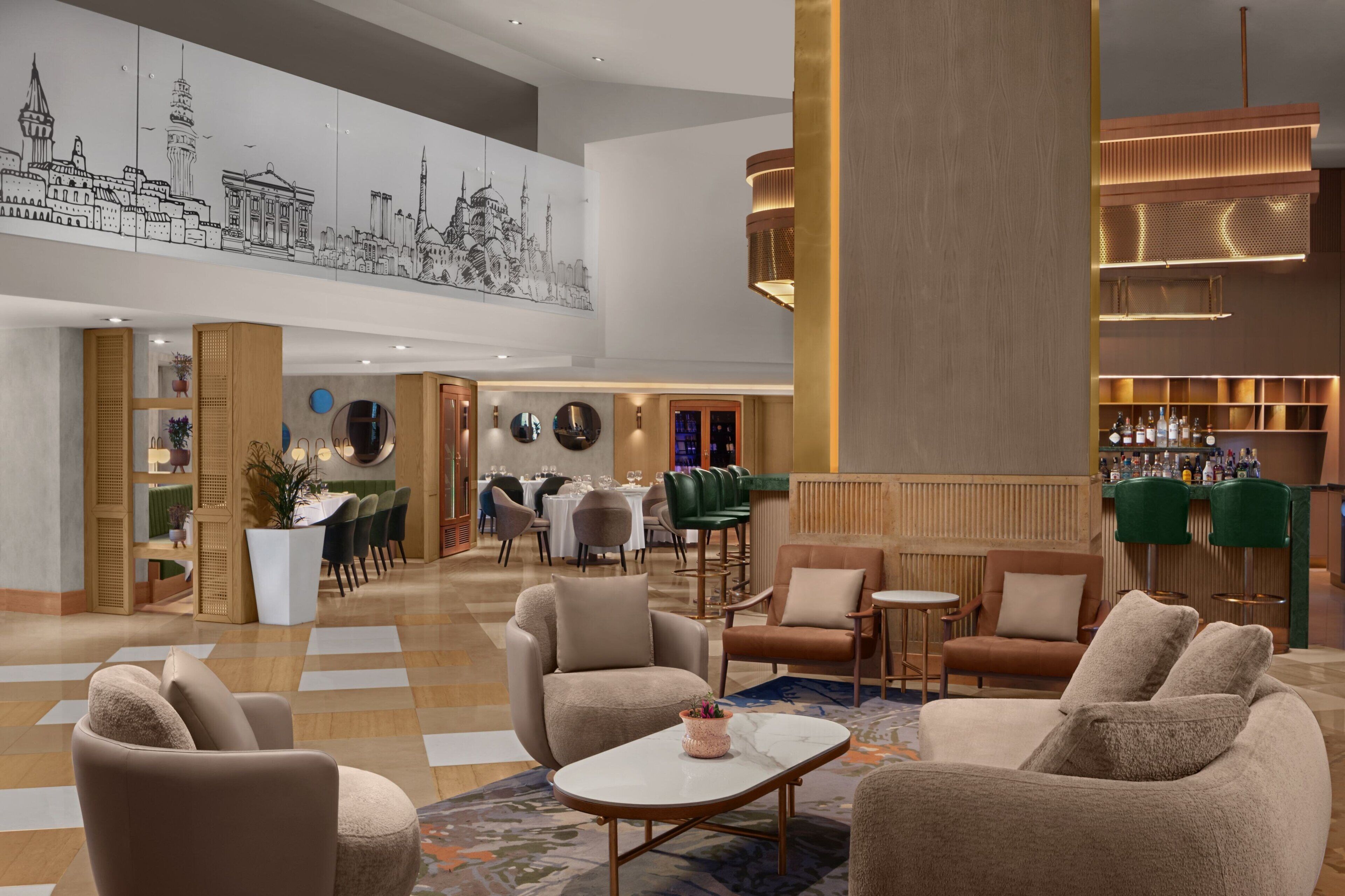 A spacious lobby with a high ceiling, a bar area, and seating arrangements.