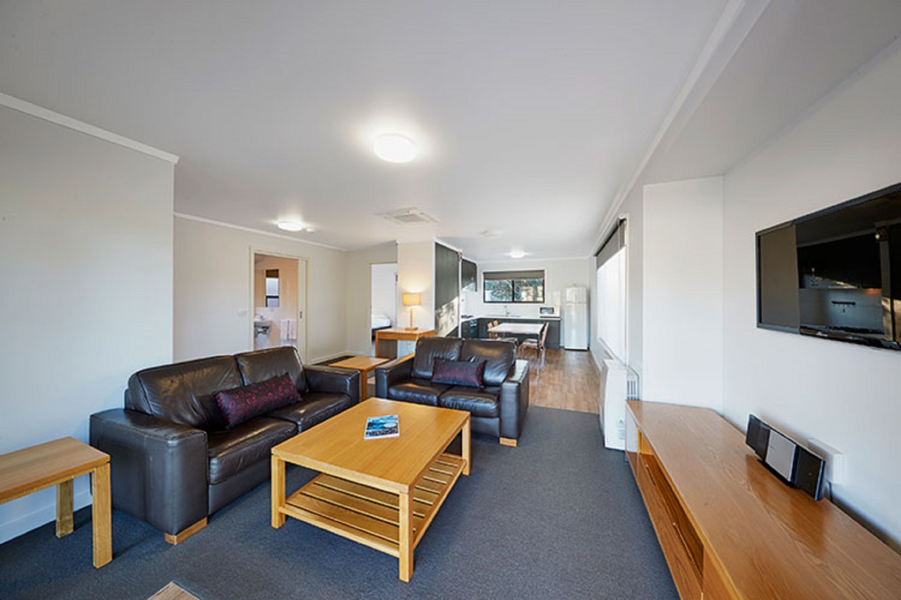 two bedroom deluxe cabin | living area | flat-screen tv, dvd player, pay films