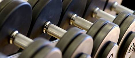 A set of black dumbbells with silver weights and a metallic bar.