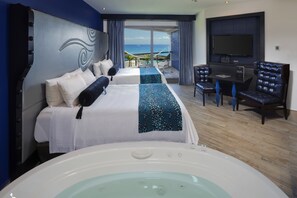 A hotel room with a large bed, a jacuzzi, a TV, and a balcony with a view of the ocean. - Adults Only Heaven at Hard Rock Hotel Riviera Maya All Inclusive (Puerto Aventuras)