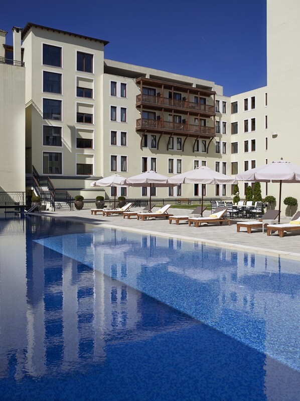 Seasonal outdoor pool, pool umbrellas, pool loungers