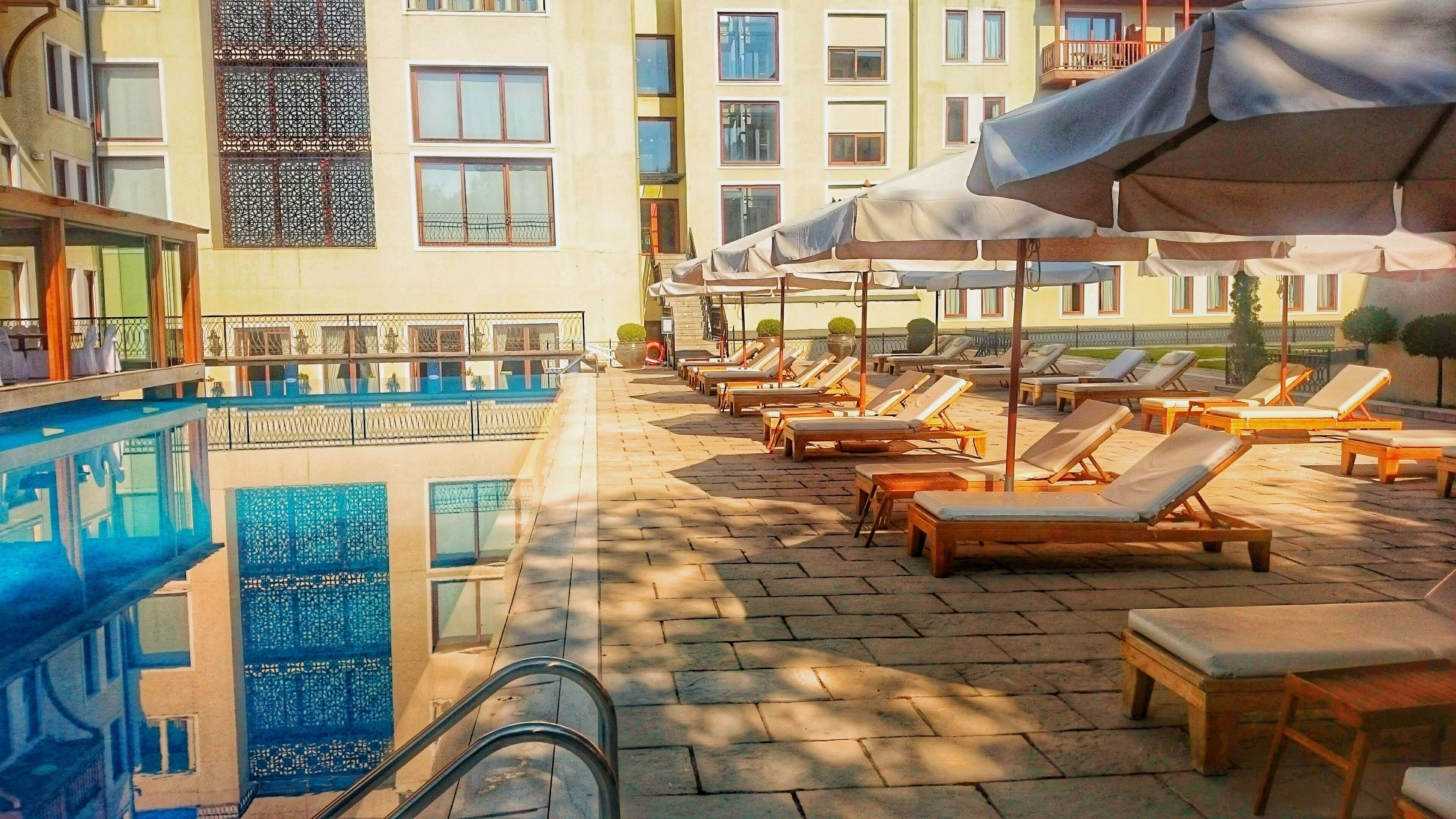 seasonal outdoor pool, pool umbrellas, pool loungers