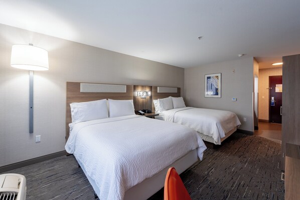 A hotel room with two beds, a nightstand, a lamp, and a painting on the wall. - Holiday Inn Express & Suites Frazier Park by IHG (Lebec)