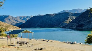 A lakeside view with a gazebo, picnic table, and rocky shoreline. - Holiday Inn Express & Suites Frazier Park by IHG (Lebec)