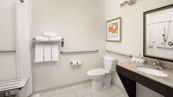 A modern bathroom with a toilet, sink, and shower.