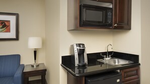 A compact kitchenette with a microwave, coffee maker, and sink. - Holiday Inn Express Hotel & Suites Uvalde by IHG (Uvalde)