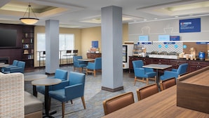 A hotel lobby with seating areas, a bar, and breakfast options. - Holiday Inn Express Hotel & Suites Uvalde by IHG (Uvalde)