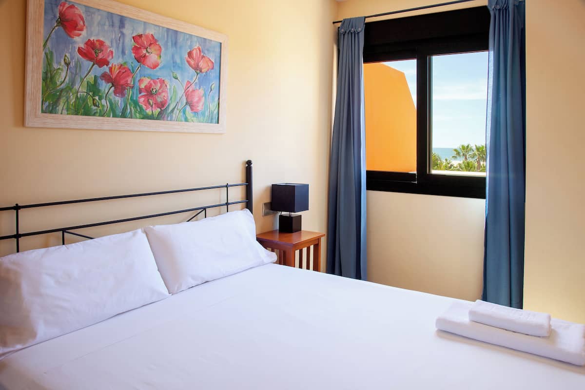 Apartment, 2 Bedrooms, Partial Sea View | In-room safe, desk, soundproofing, free cribs/infant beds