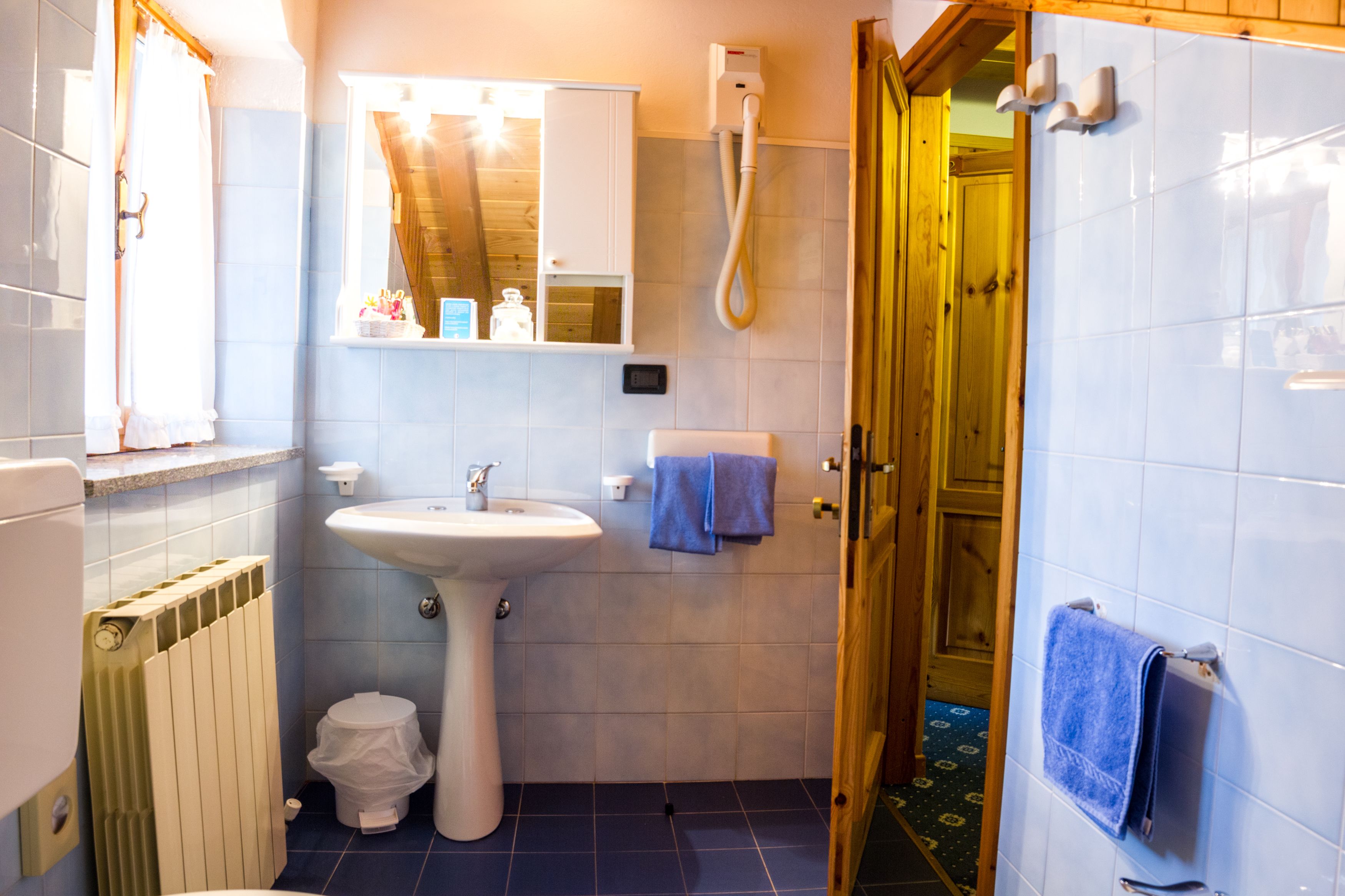 A bathroom with a sink, toilet, and shower.