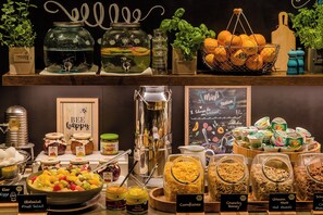 A buffet with various food options including fruits, salads, and cereals. - Motel One Leipzig-Nikolaikirche (Leipzig)