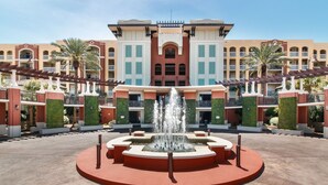A hotel with a central fountain, multiple balconies, and a symmetrical facade. - Azure Condominiums (Fort Walton Beach)
