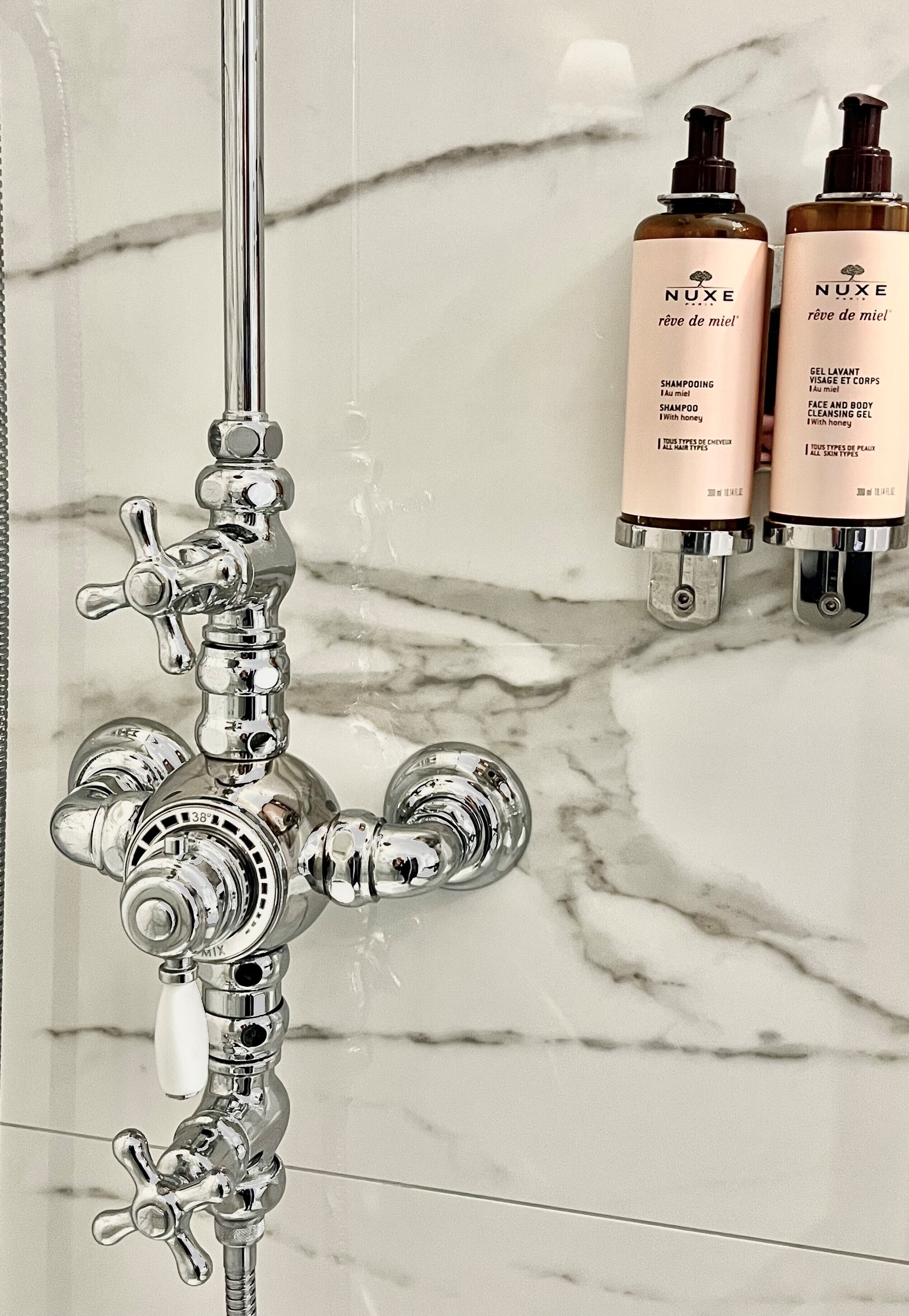 designer toiletries, hair dryer, slippers, towels