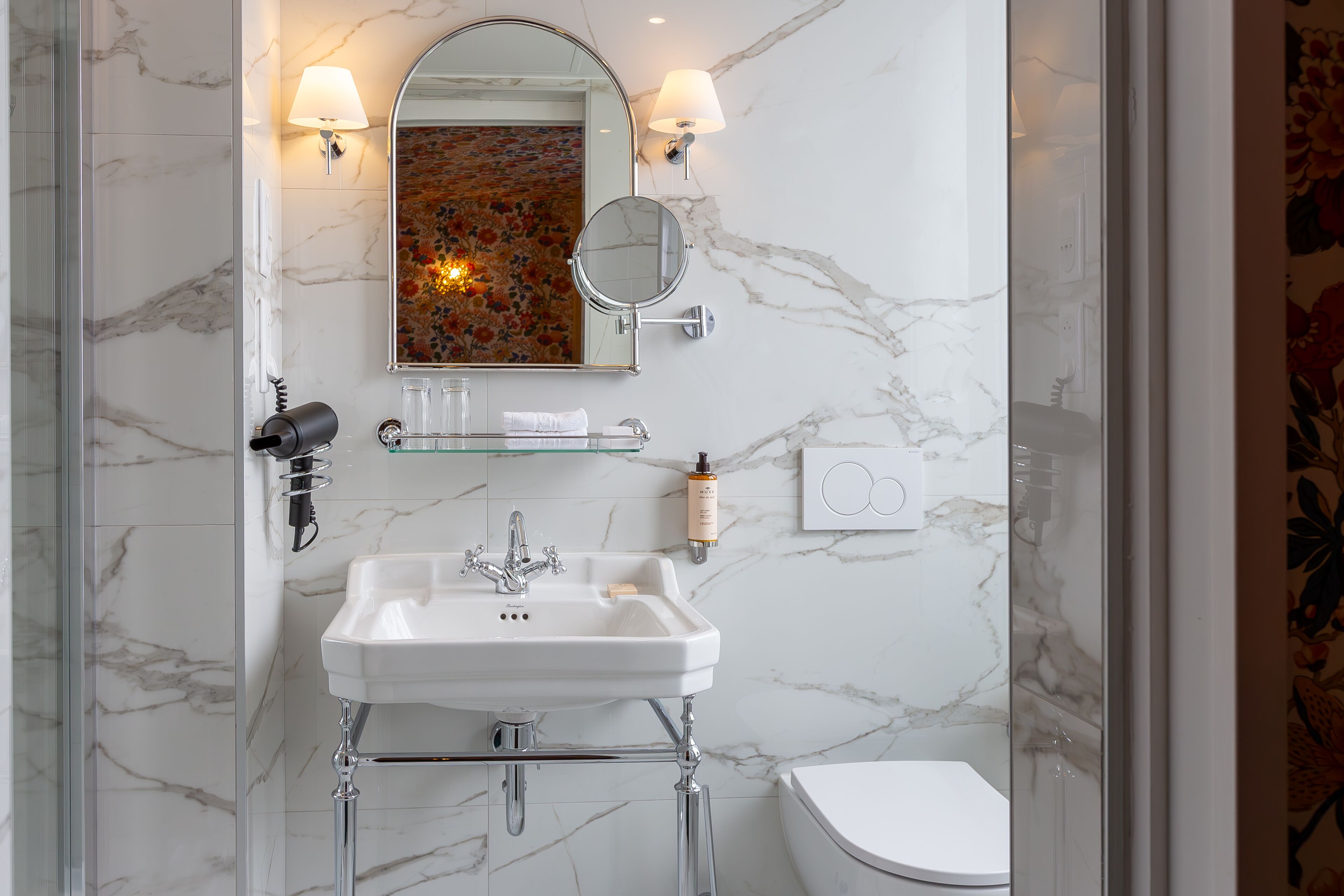 designer toiletries, hair dryer, slippers, towels