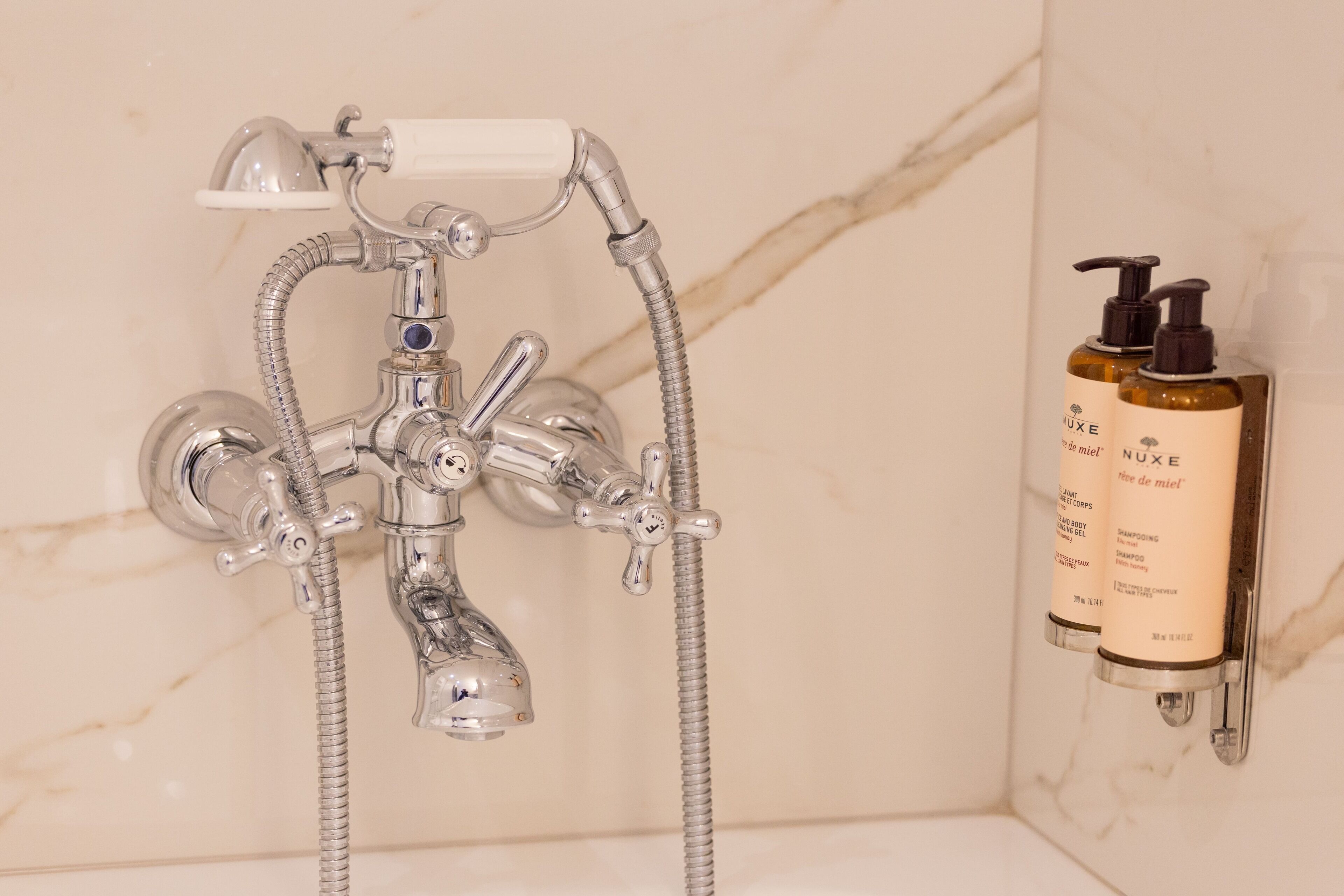 designer toiletries, hair dryer, slippers, towels