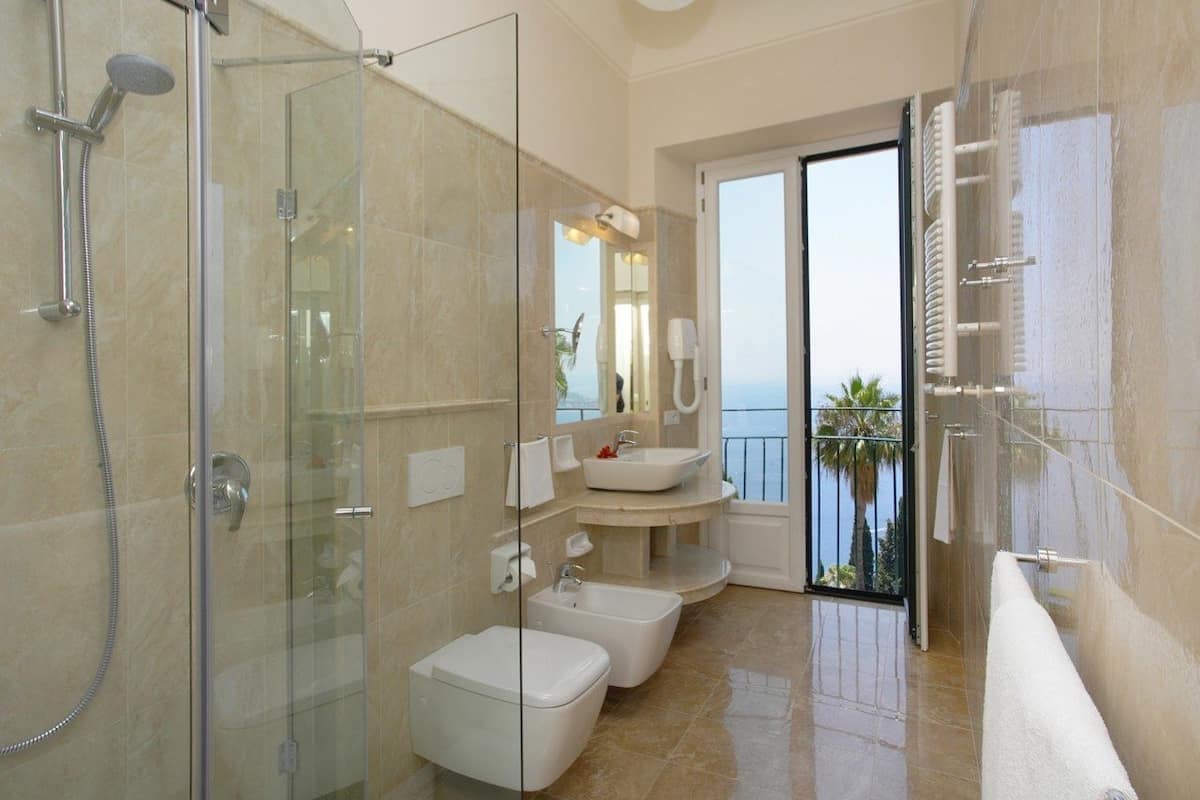 classic room, 1 double or 2 single beds, sea facing | bathroom | designer toiletries, hair dryer, bathrobes, bidet