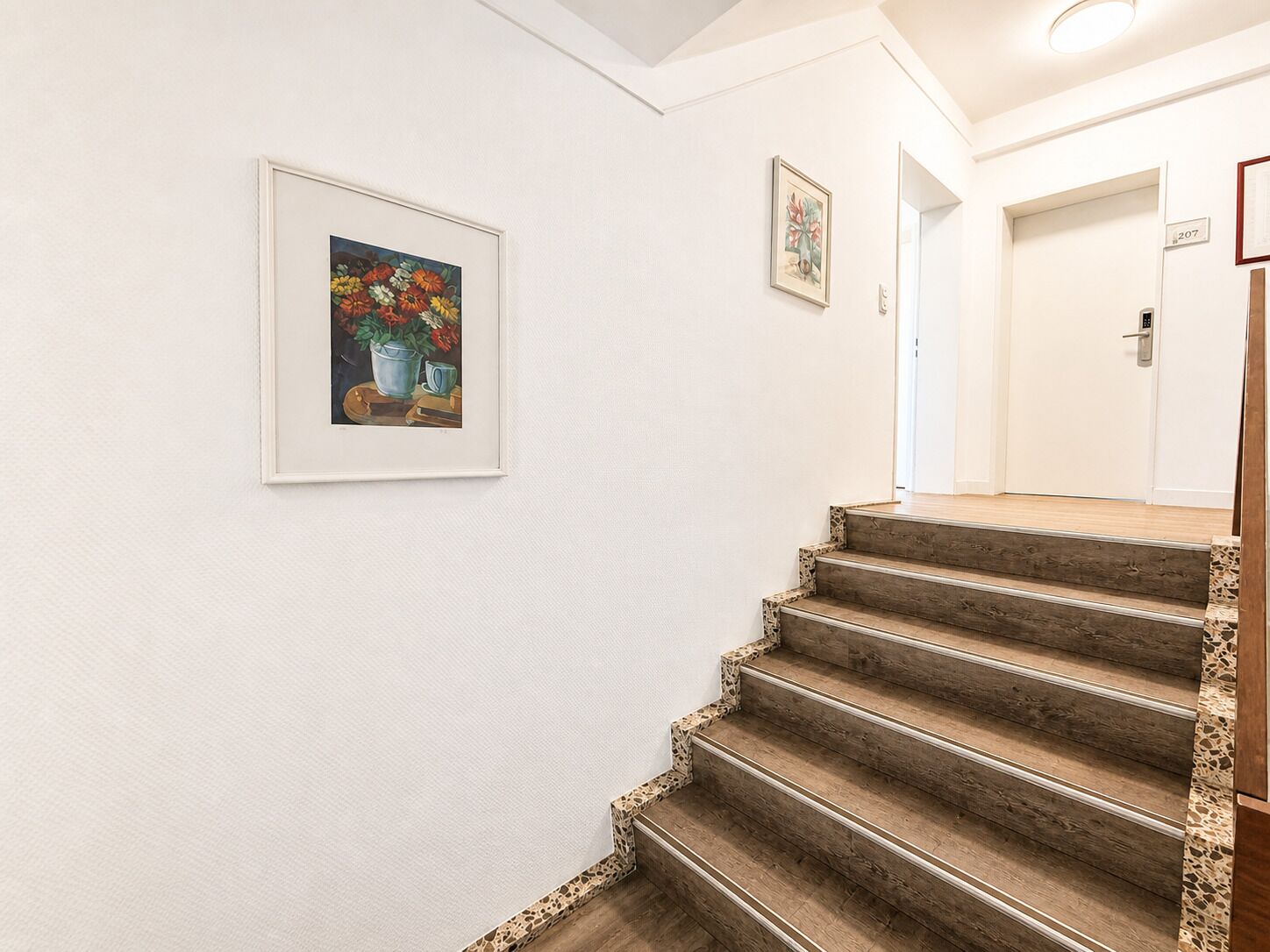 A staircase with wooden steps and a textured wall.