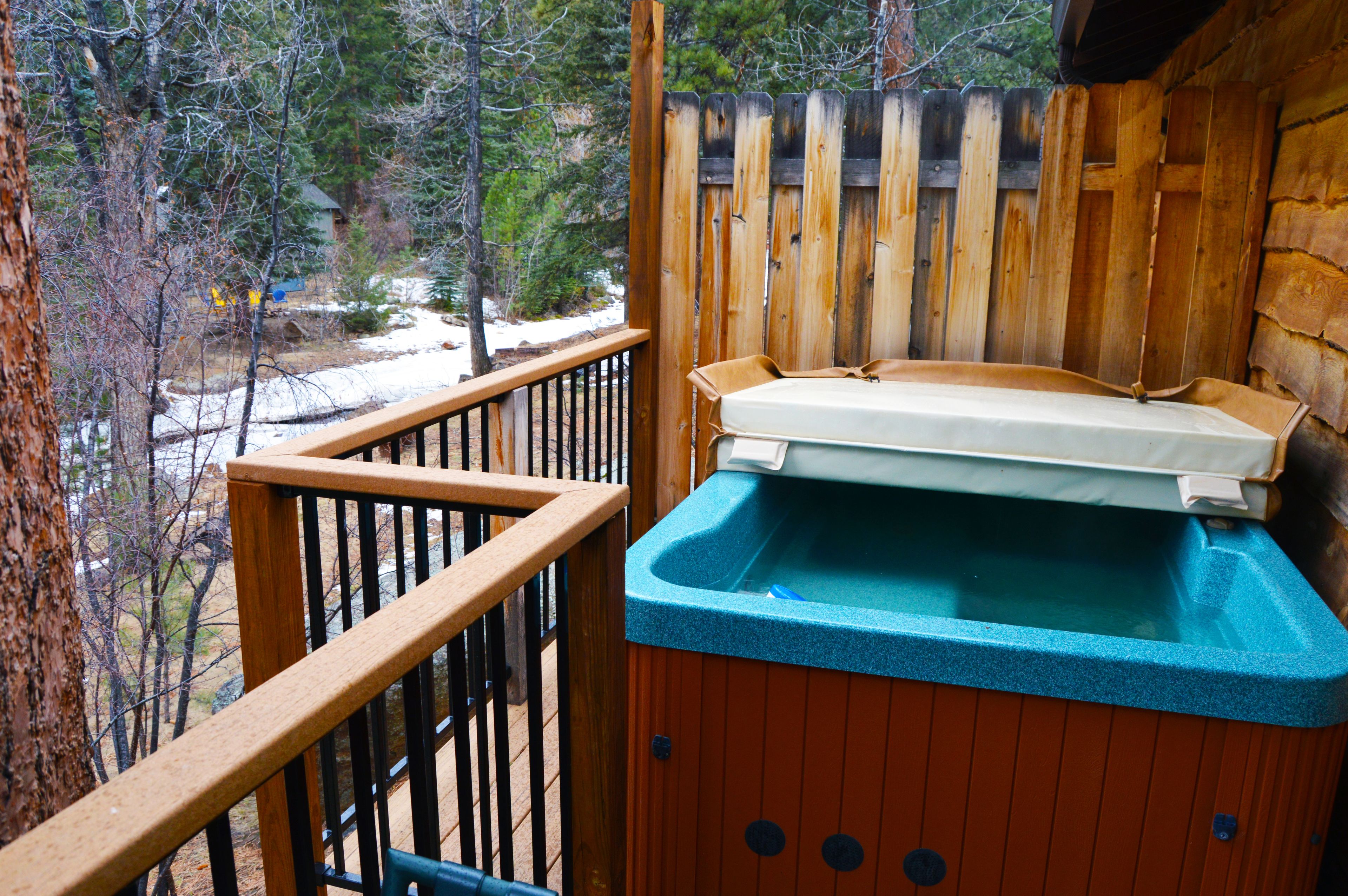 A wooden deck with a hot tub.