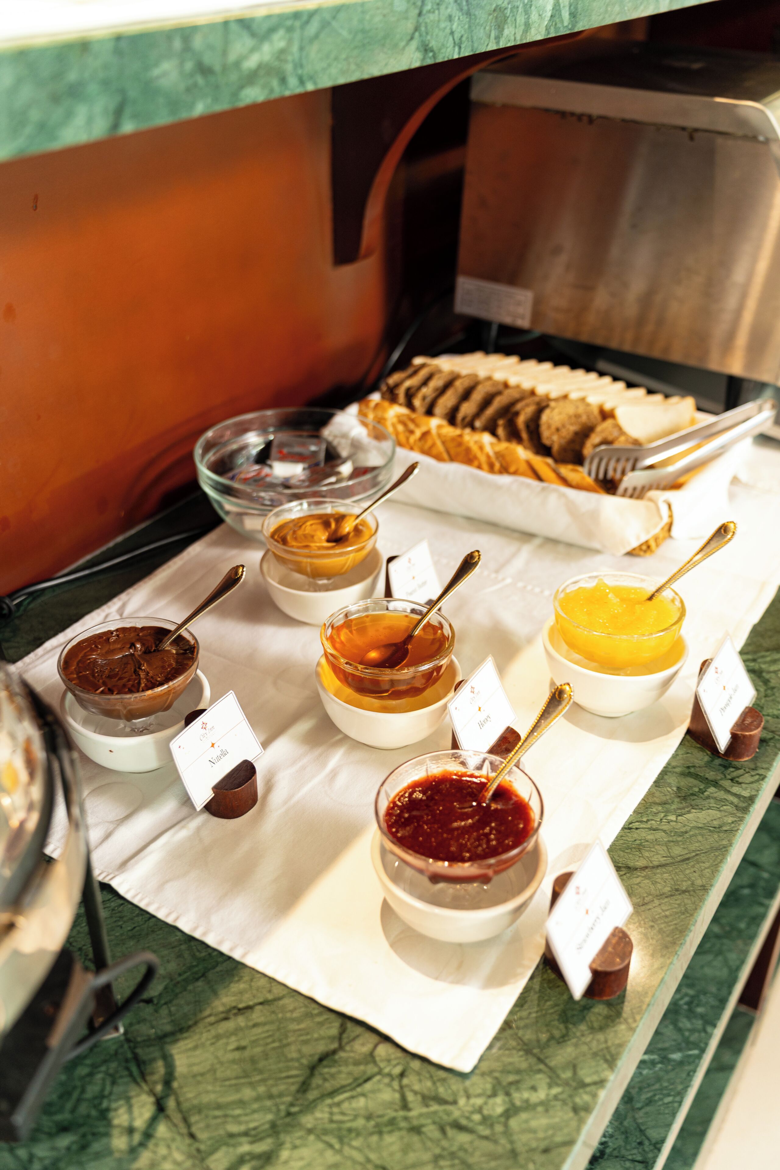 A buffet with various food items and condiments.