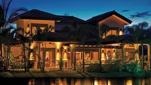 A two-story house with a swimming pool in front, surrounded by tropical vegetation. - The Buenaventura Golf & Beach Resort Panama, Autograph Collection (El Chiru)