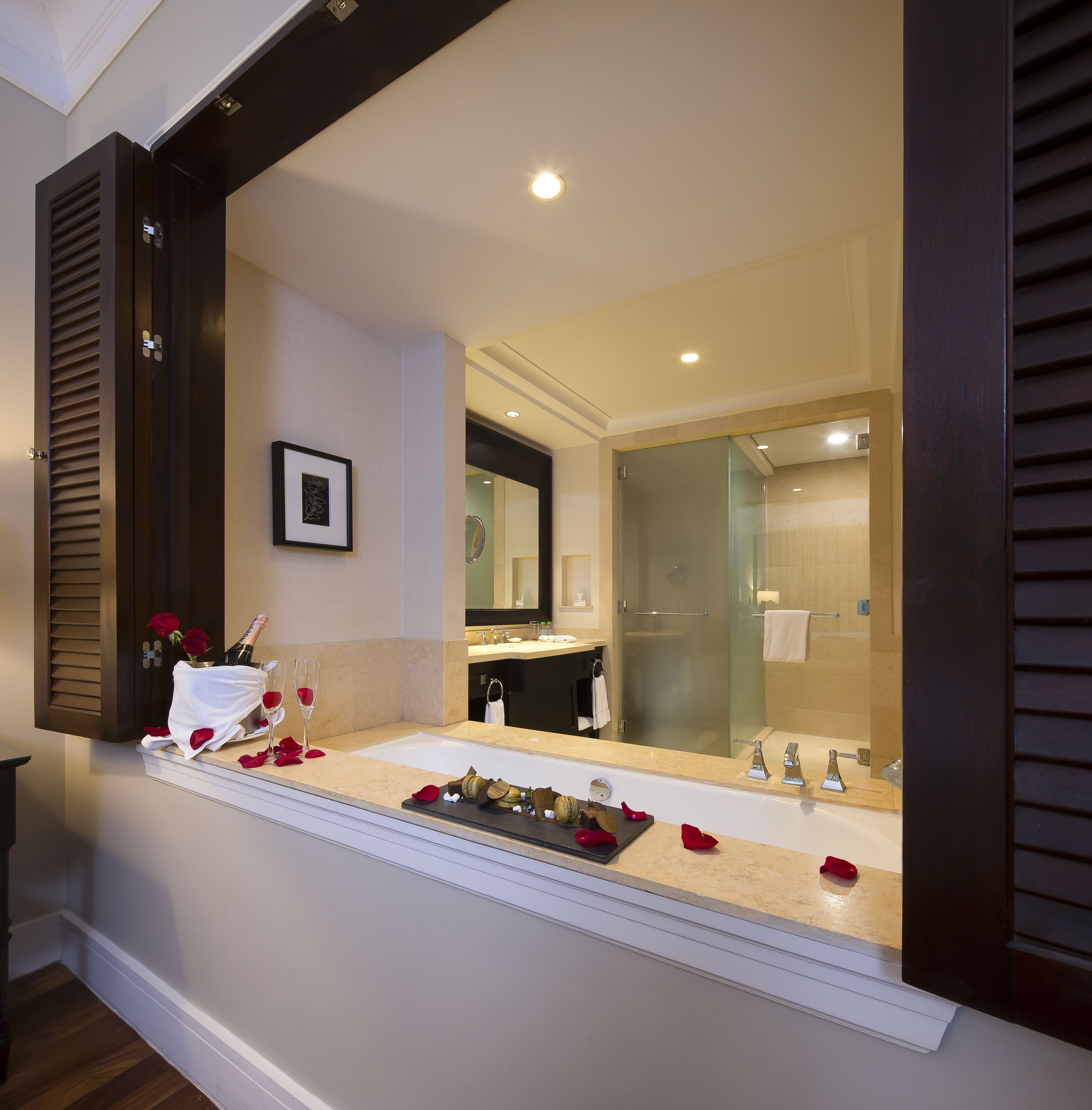A modern bathroom with a large mirror, a sink, and a shower.