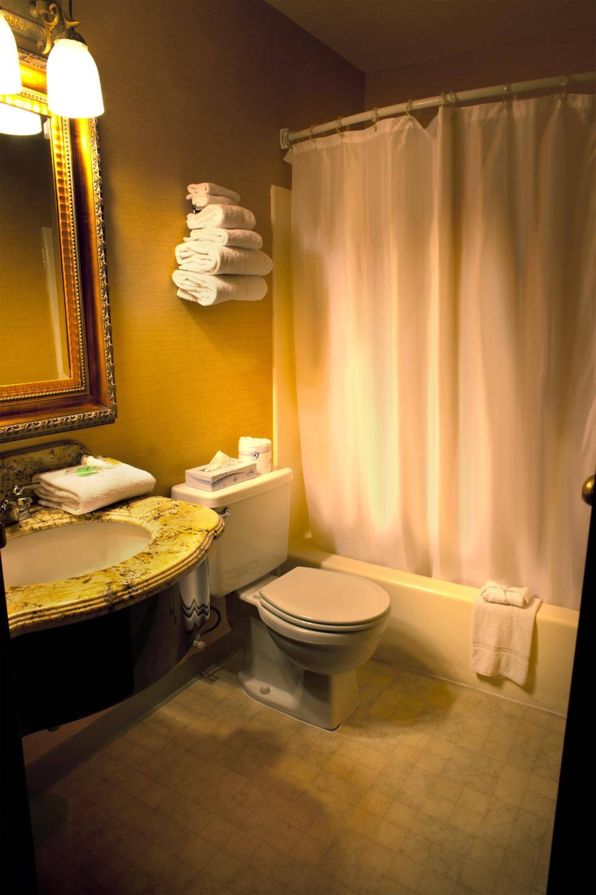 A bathroom with a sink, toilet, and bathtub.
