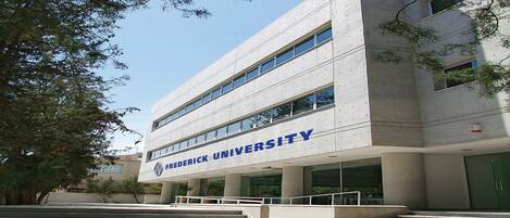 A modern building with the name 'Frederick University' prominently displayed.