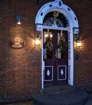 A brick building with a white arched entrance and a sign reading "Curry House 148". - Carlisle House (Carlisle)