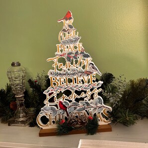 A Christmas tree with a message that reads "A place where you can find peace, family, and believe in Christmas." - Carlisle House (Carlisle)