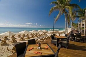 On the beach, sun-loungers, beach umbrellas, beach towels