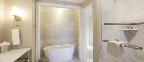 A bathroom with a bathtub, toilet, and shower.